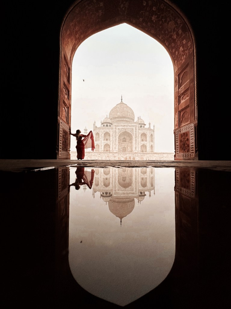 Retrato personal frente al Taj Mahal reflejado en el agua, en un momento sin turistas, capturando la majestuosidad del monumento como fondo exclusivo